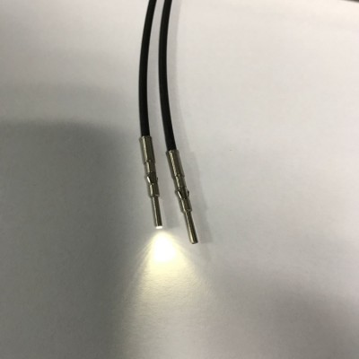 The RMPOF1000B plastic fiber optic patch cord port emits a stable white light signal.