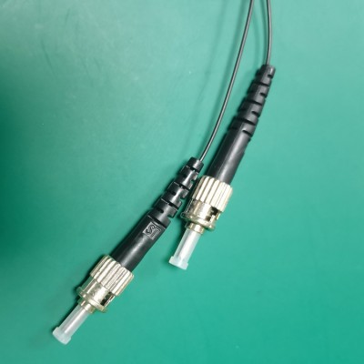 ST-1 1x2 optical splitter full view, coiled black fiber optic cable with dual connectors, demonstrating flexible cable management and industrial design